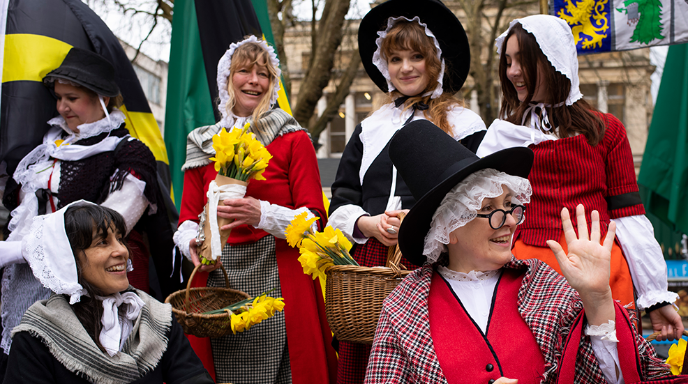 A group of women are dressed in traditional Welsh dress during St David's Day parade in the city centre of Cardiff